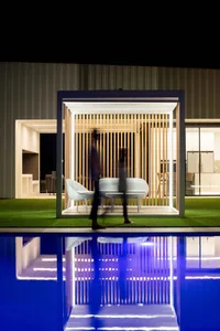 An outdoor garden retreat featuring a minimalist design with a wooden terrace.