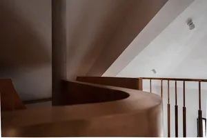 Minimalist space featuring metal railings and steps.