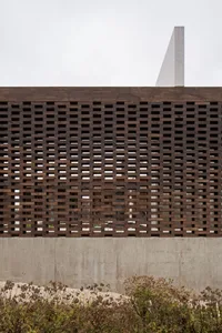Modern building facade with wooden lattice and concrete base