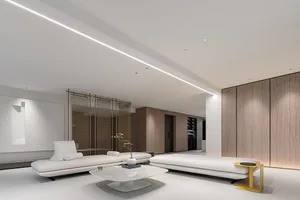 Modern white leather living room with large sofas and a coffee table.