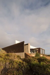 A modern architecture house with a contemporary design, featuring wood and glass materials.
