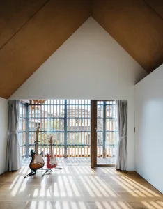 A modern music room featuring wooden guitar stands.