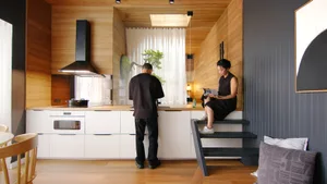 A modern kitchen with white cabinets and wooden paneling