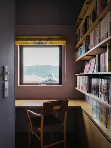 A minimalist bookshelf made of wood with books and shelves arranged neatly on shelves.