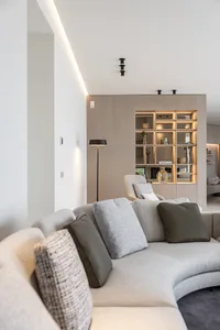 A modern living room with neutral-toned furnishings and minimalist decor.