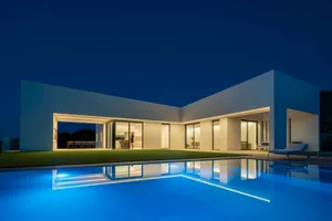 A modern residential home featuring concrete and glass materials.
