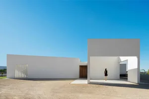A modern building with clean lines and white concrete exterior.