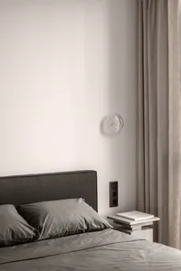 Neutral materials in a minimalist bedroom setting.