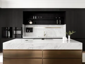 Modern kitchen with black cabinetry and marble countertops.