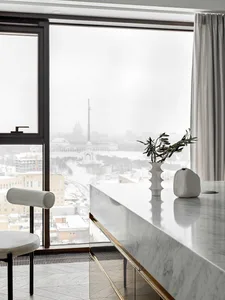 Modern kitchen with a marble countertop featuring sleek, minimalist design.