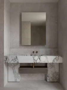 A minimalist bathroom with marble accents and a floating vanity.