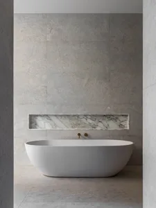 Modern bathroom interior with marble walls and floor, featuring a freestanding tub and gold faucets.