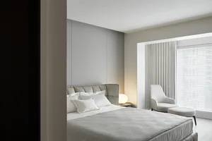 A modern minimalist bedroom with a double bed, white sheets, and a headboard in front of a large window with curtains.
