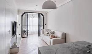 A modern living room featuring neutral tones and minimalist furniture.