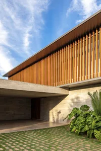 A modern exterior building with horizontal wooden slats and a concrete base.