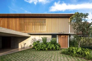 A modern house with wooden exterior and a clear blue sky.