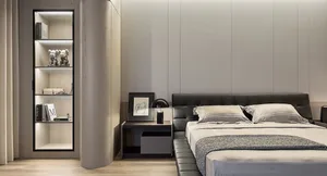 A minimalist bedroom with a black leather bed, wooden floor, and light-colored walls.