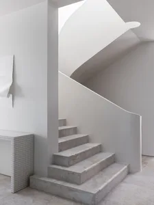 Modern, minimalist staircase constructed from concrete materials.