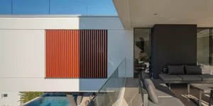 Modern residential patio featuring concrete and glass elements.
