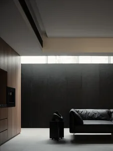 A modern interior design featuring a black leather sofa against a textured black wall, complemented by sleek wooden cabinets 