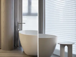 Modern bathroom featuring a freestanding ceramic bathtub with sleek design.