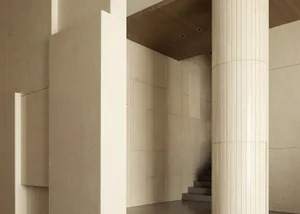A photograph of a modern architectural interior featuring concrete and marble materials.