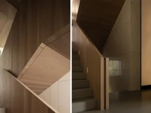 Staircase with wooden walls and steps in a minimalist interior design.