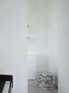 Minimalist interior design featuring marble accents and wood finishes.