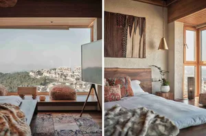 A cozy wooden bedroom featuring a bed with a wooden headboard, patterned cushions, and a large window with a view of the city