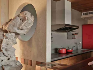 A modern minimalist kitchen featuring sleek stainless steel appliances and minimalist design elements.