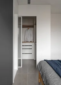 A minimalist bathroom featuring concrete and wooden elements.