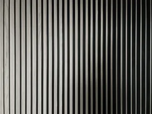Minimalist metallic panels creating a vertical striped pattern on a wall