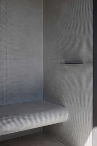 Modern bathroom featuring tiled and concrete walls
