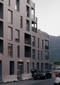 Modern apartment building with concrete exterior and balconies.