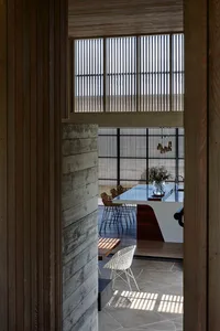 Modern interior design featuring wooden walls, concrete lighting, and glass railings.