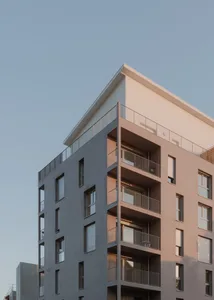 Modern residential building made of concrete with multiple balconies and windows.