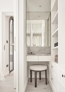 A modern closet with white marble counter and wooden stool
