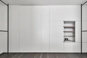 A modern, white storage cabinet with sleek, minimalist design and multiple storage compartments.