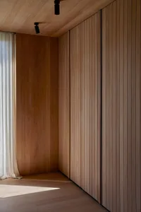 Modern interior design featuring wooden walls and ceiling.