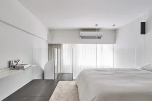 A minimalist bedroom with a glass divider, bed, and floating shelves.
