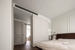 Minimalist bedroom with modern white furniture and materials.