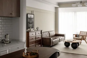 A minimalist residential living room featuring wooden furniture, leather accents, and glass elements.
