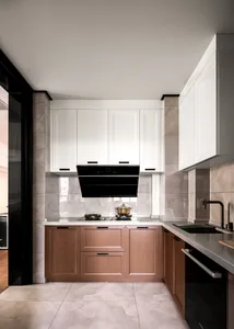 Modern kitchen with marble countertops, wooden cabinets, and a black stove.