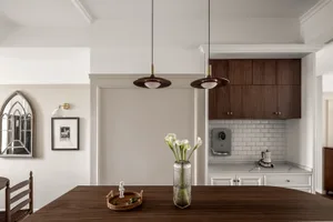 A modern kitchen featuring wooden elements and a marble backsplash.