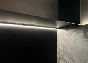 A minimalist design featuring black metallic walls with a sleek, modern aesthetic.