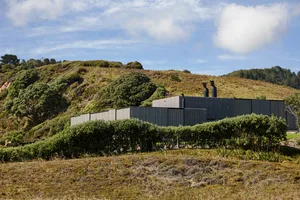 Modern residential building featuring metal siding and a contemporary design.