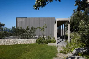 A modern residential architecture featuring a wooden exterior.