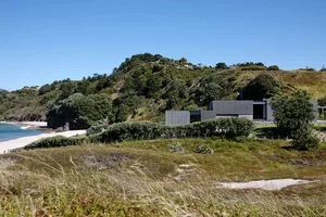 Modern residential house near the beach surrounded by greenery