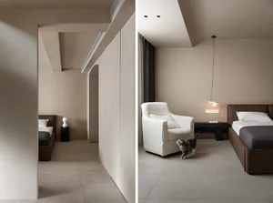 A modern bedroom with minimalist design featuring concrete walls and floor.