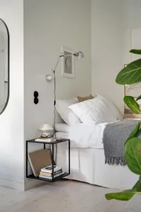 A minimalist bedroom featuring soft textiles and simple furnishings.